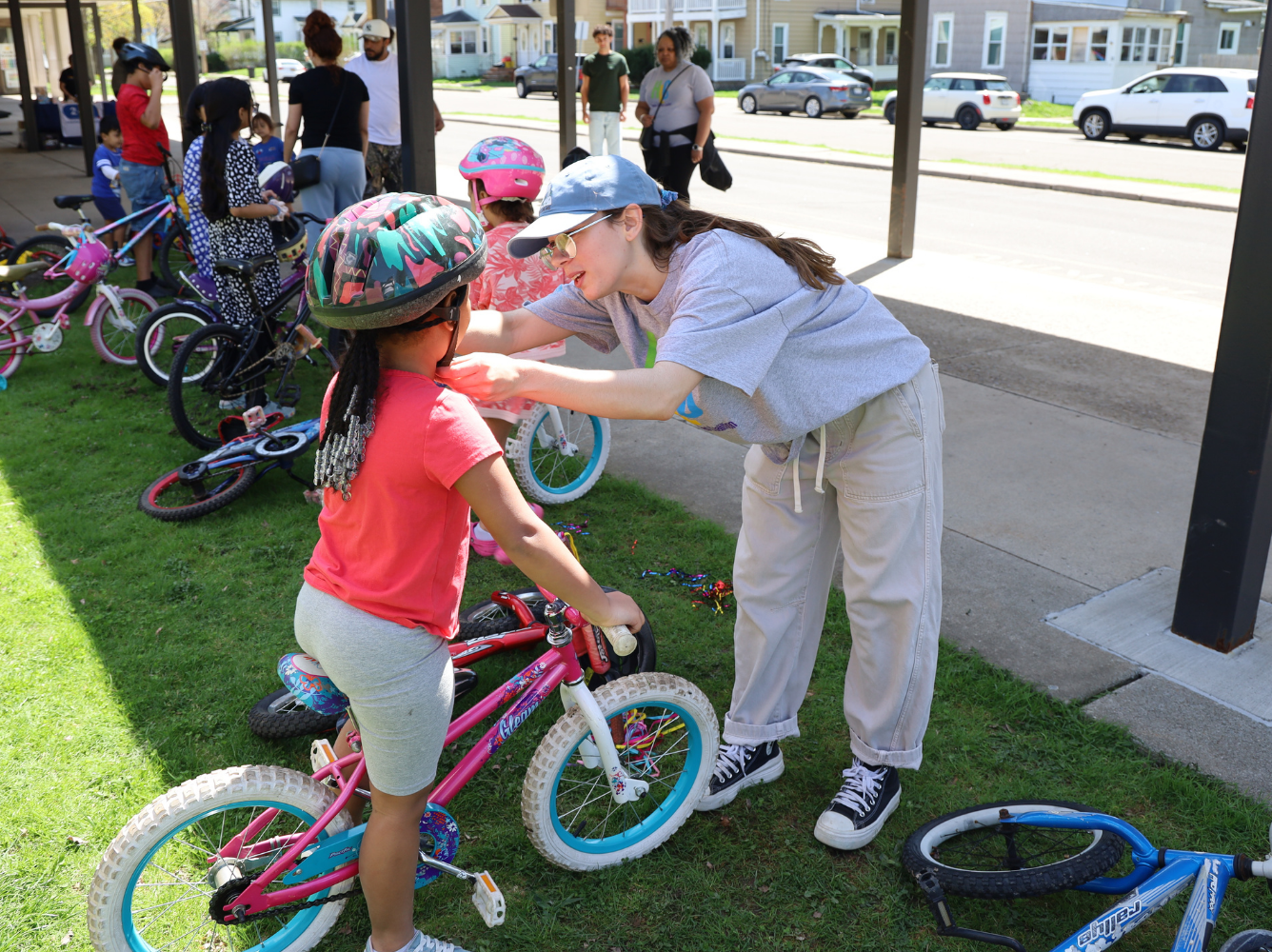 Child on bike receiving helmet
